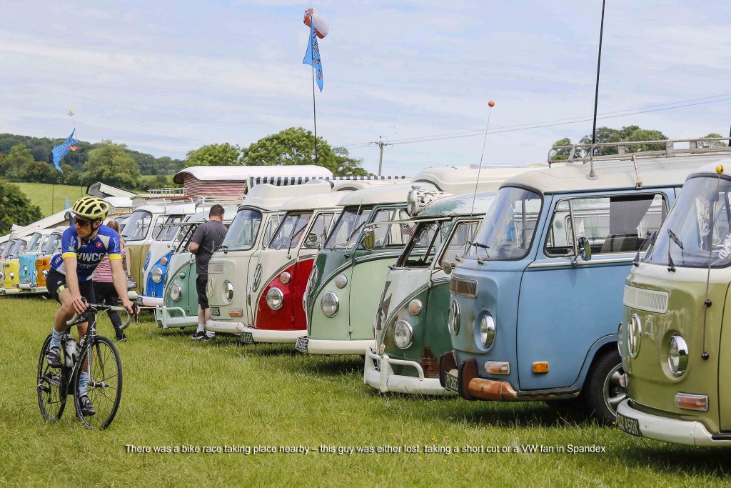 Man on a bike in front of VW Campervans